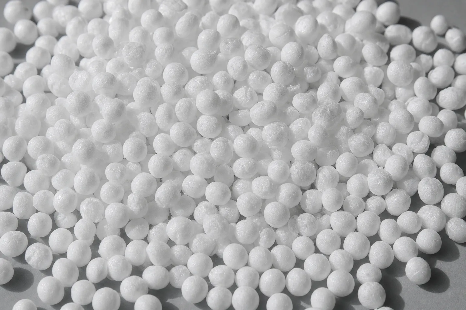 Close-up of expanded polystyrene beads, showing particle size and texture.