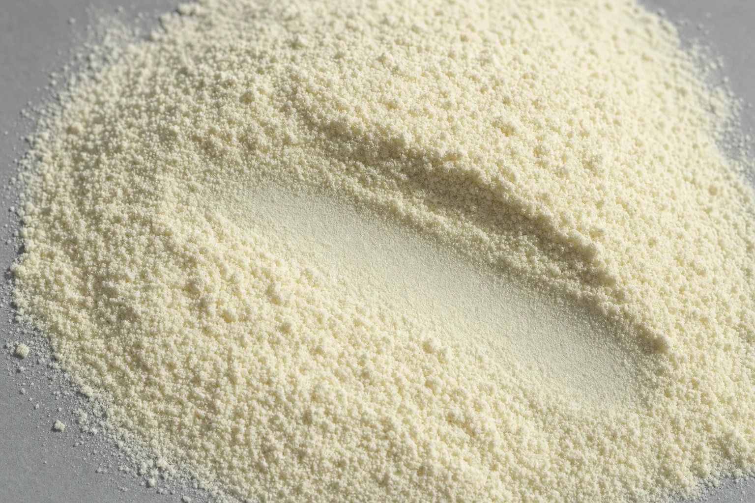 Close-up of infant formula powder, showing particle size and texture.