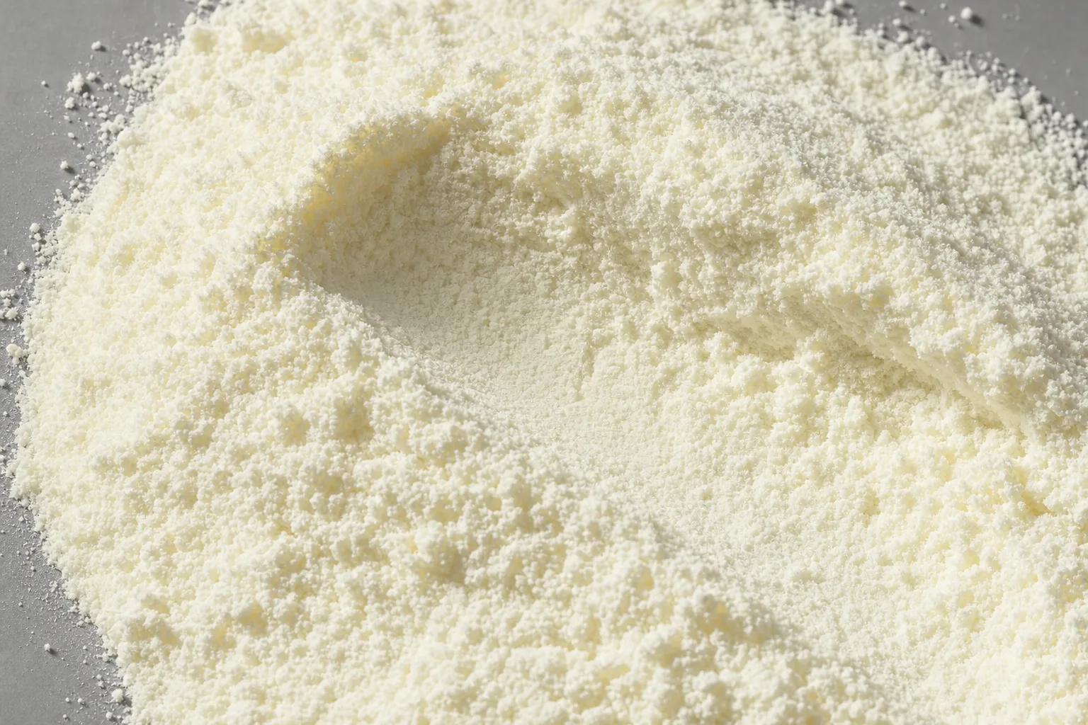 Close-up of milk powder, showing particle size and texture.