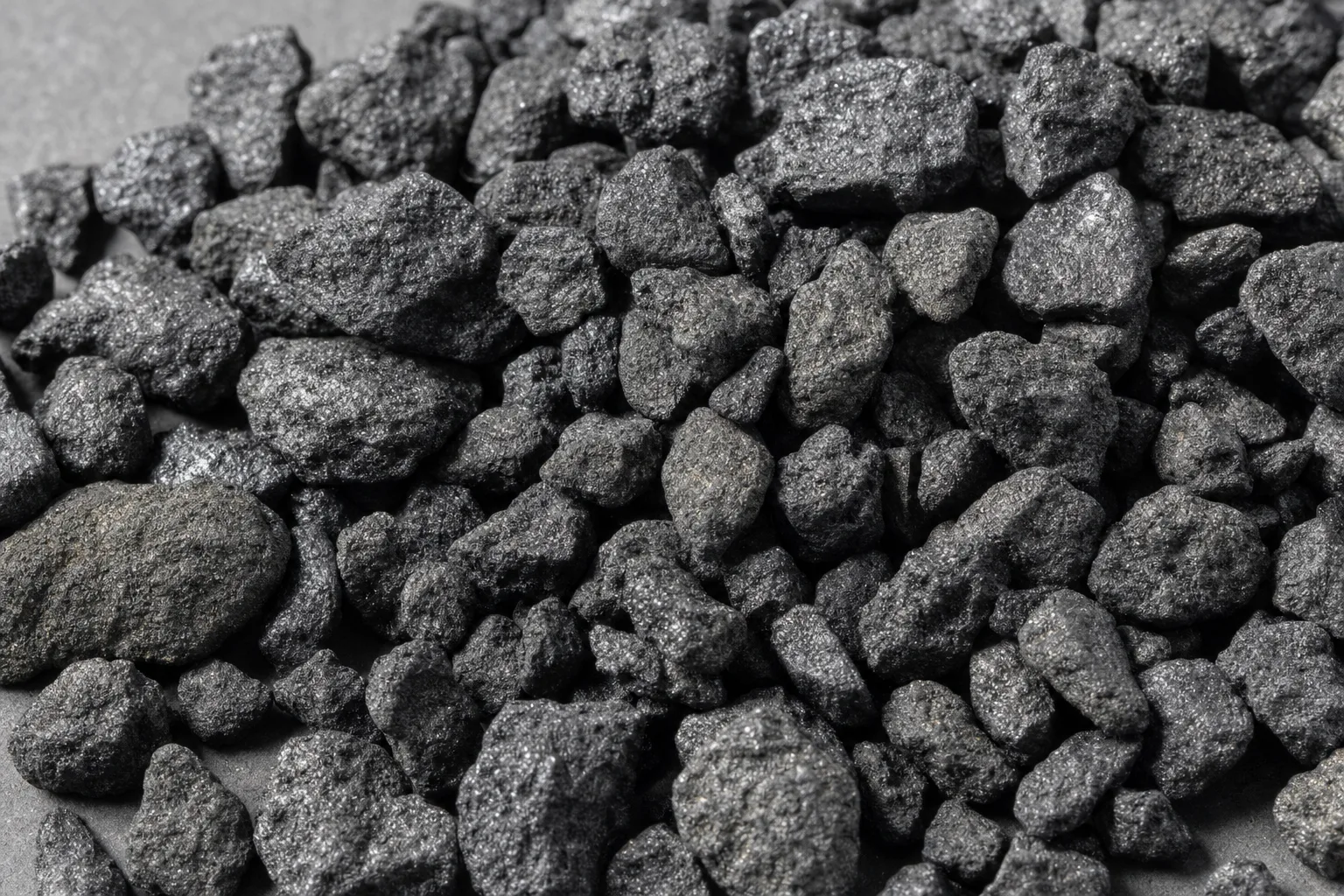 Close-up of petroleum coke, showing particle size and texture.