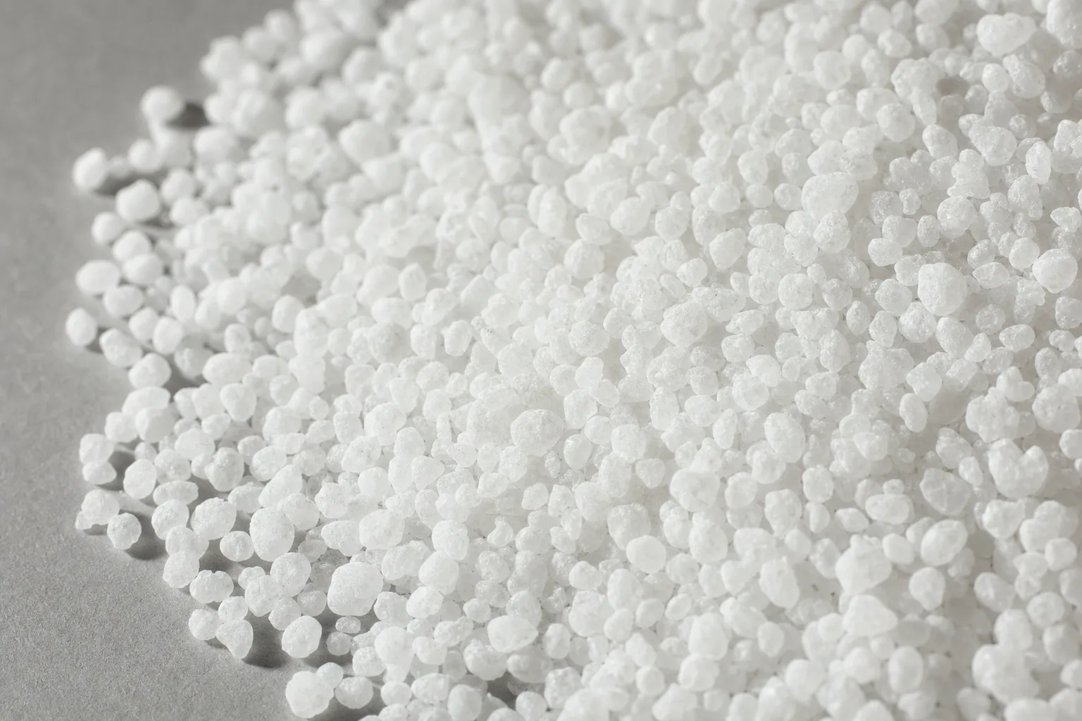 Close-up of urea fertilizer, showing particle size and texture.